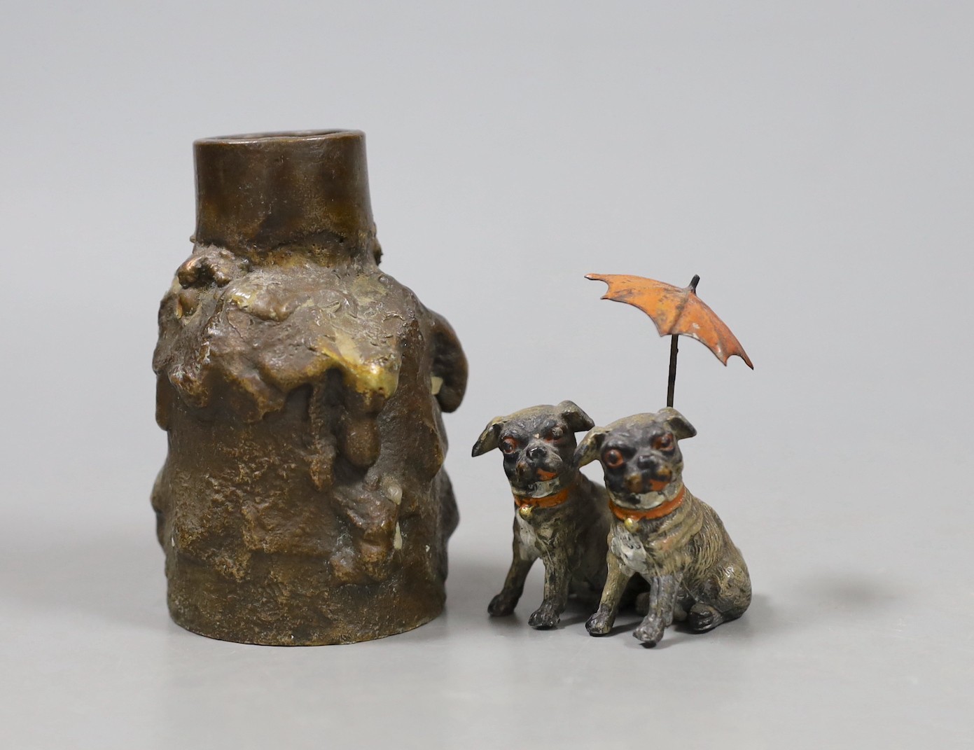 A cold painted spelter pug group and a heavy bronze abstract candlestick. Tallest 9cm